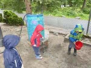 students playing with water outside